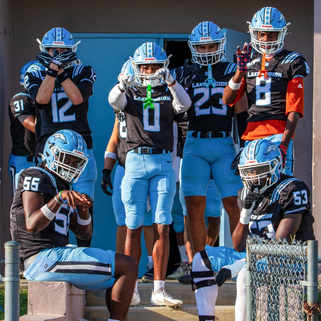 Lake Region football players in coordinated black jerseys and blue pants