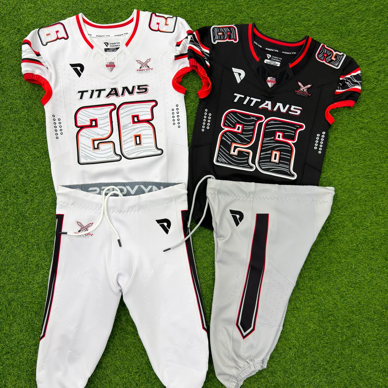 PROVYN Titans 26 white and black football jerseys with red trim and two coordinated white football pants